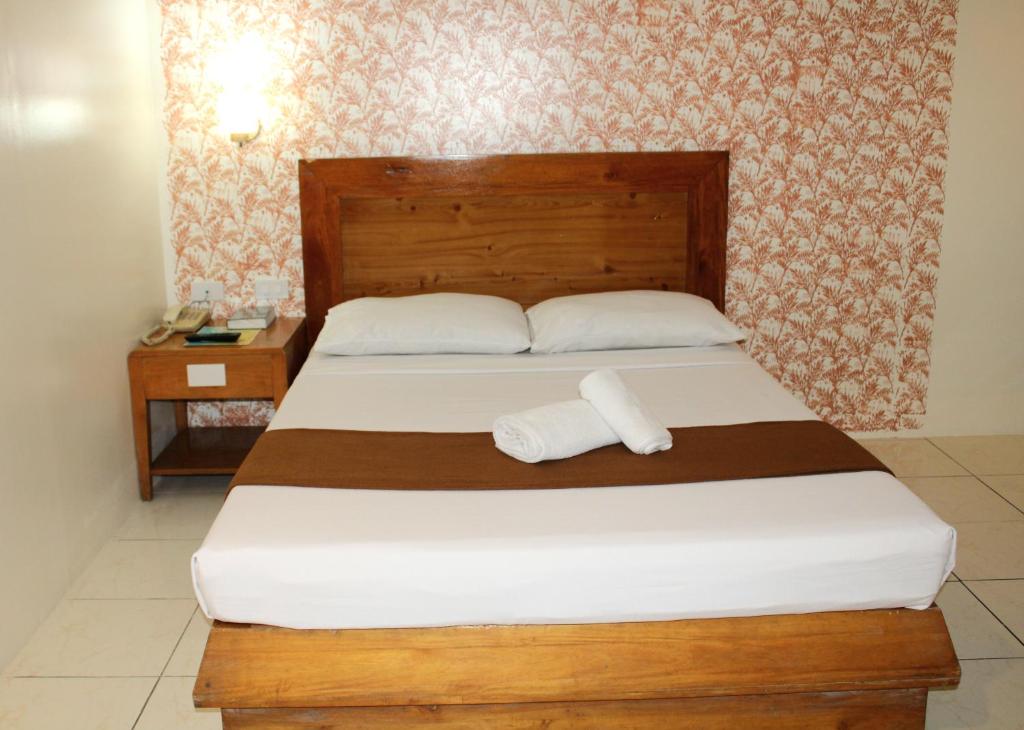 Postel nebo postele na pokoji v ubytování Rosas Garden Hotel
