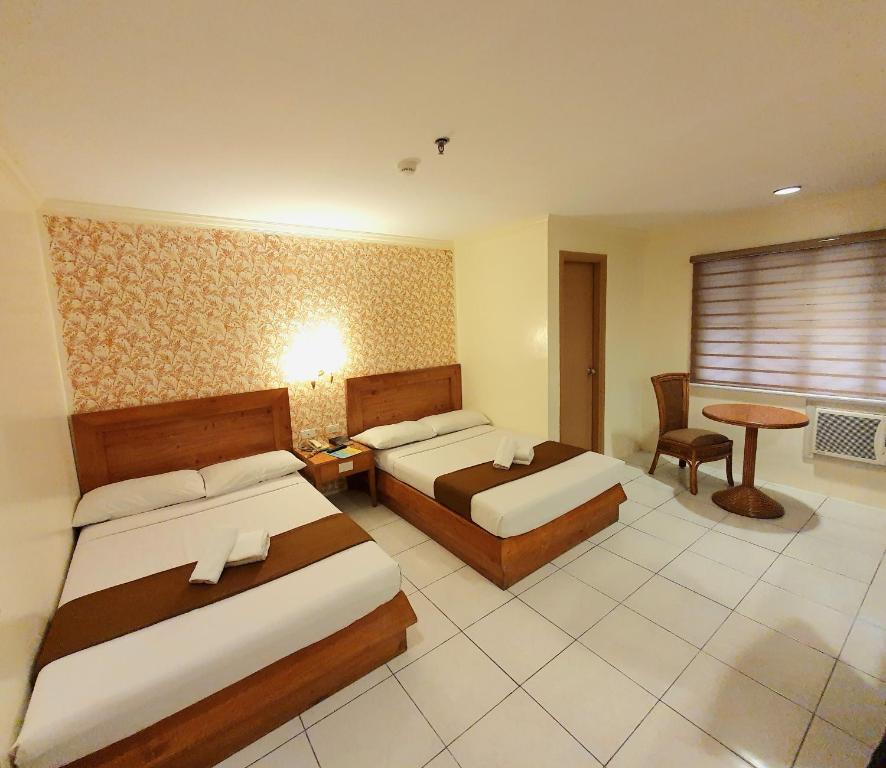 Postel nebo postele na pokoji v ubytování Rosas Garden Hotel