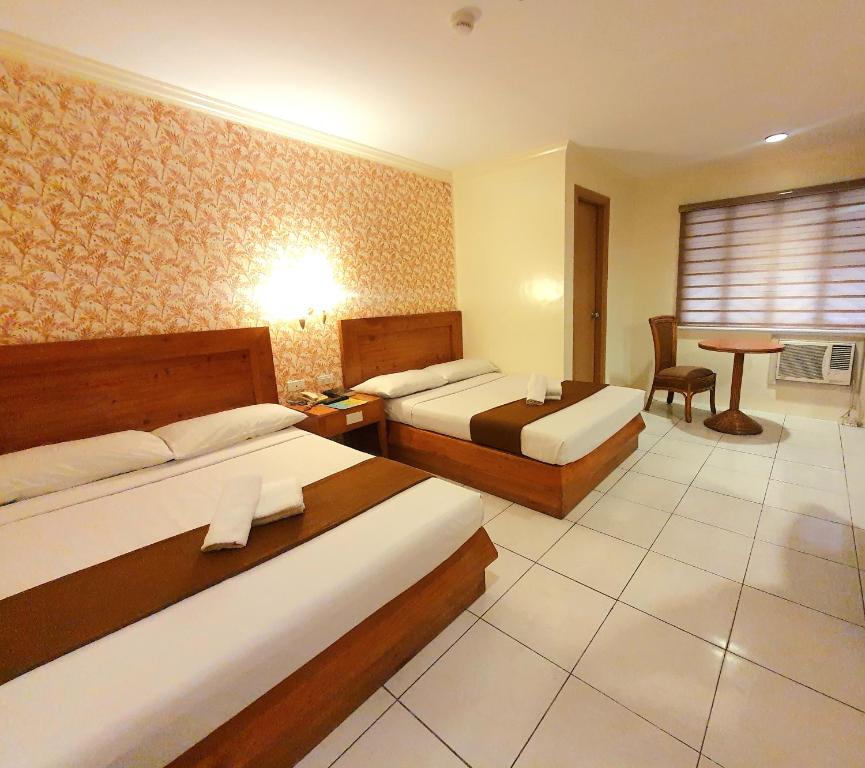 Postel nebo postele na pokoji v ubytování Rosas Garden Hotel