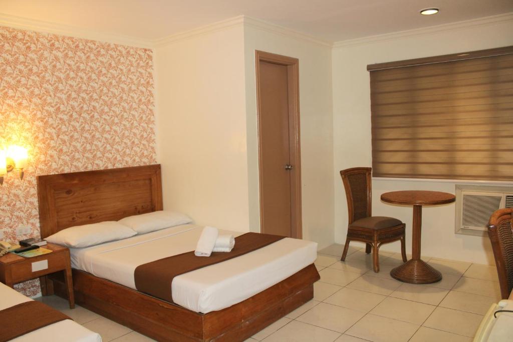 Postel nebo postele na pokoji v ubytování Rosas Garden Hotel