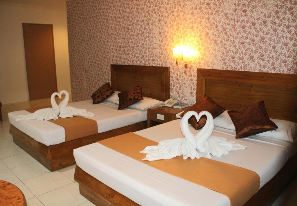 Postel nebo postele na pokoji v ubytování Rosas Garden Hotel