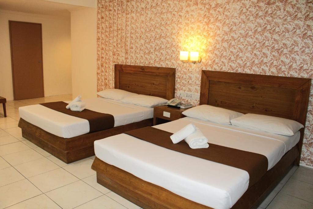 Postel nebo postele na pokoji v ubytování Rosas Garden Hotel