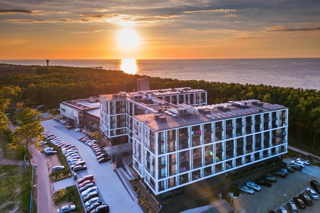 an aerial view of a building with a parking lot at Hotel Zalewski in Mrzeżyno