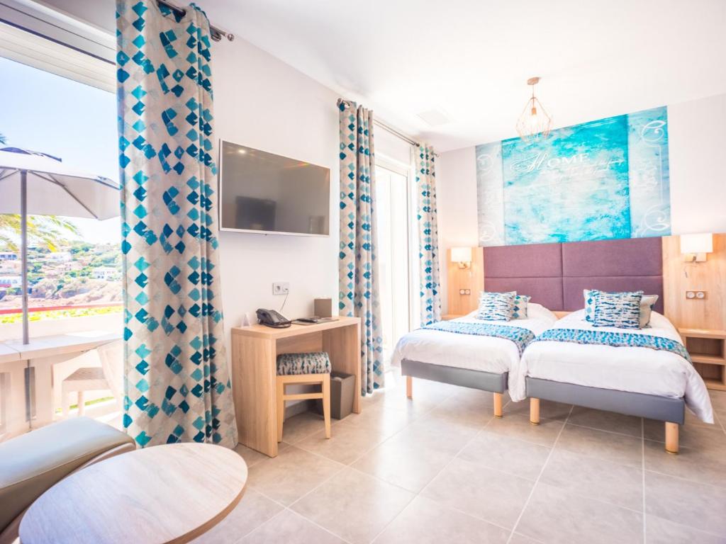 Postel nebo postele na pokoji v ubytování Hôtel et Appart Hôtel Les Flots Bleus