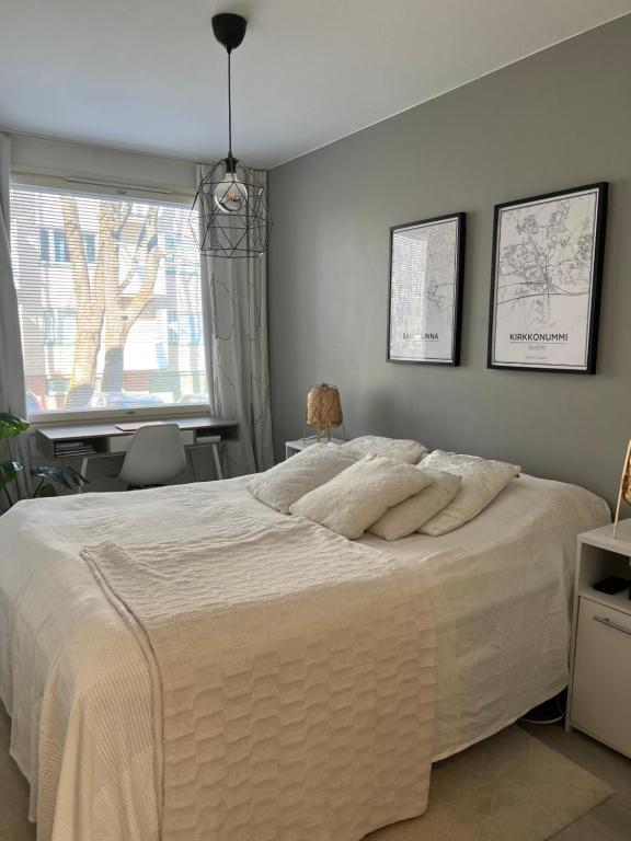 a bedroom with a large bed and a window at Kaksio Helsingissä omalla parkkipaikalla in Helsinki