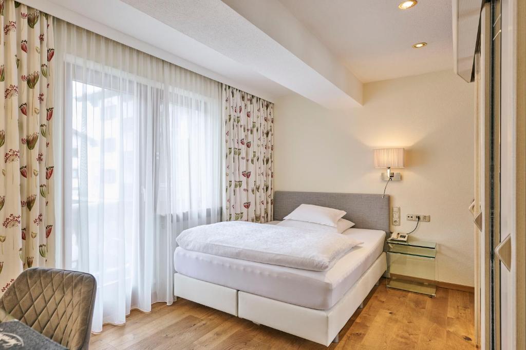 Posteľ alebo postele v izbe v ubytovaní Hotel Garni Sursilva