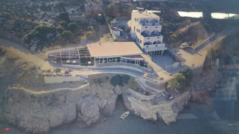 an aerial view of a house on a cliff at Kazonis Studios in Kalymnos