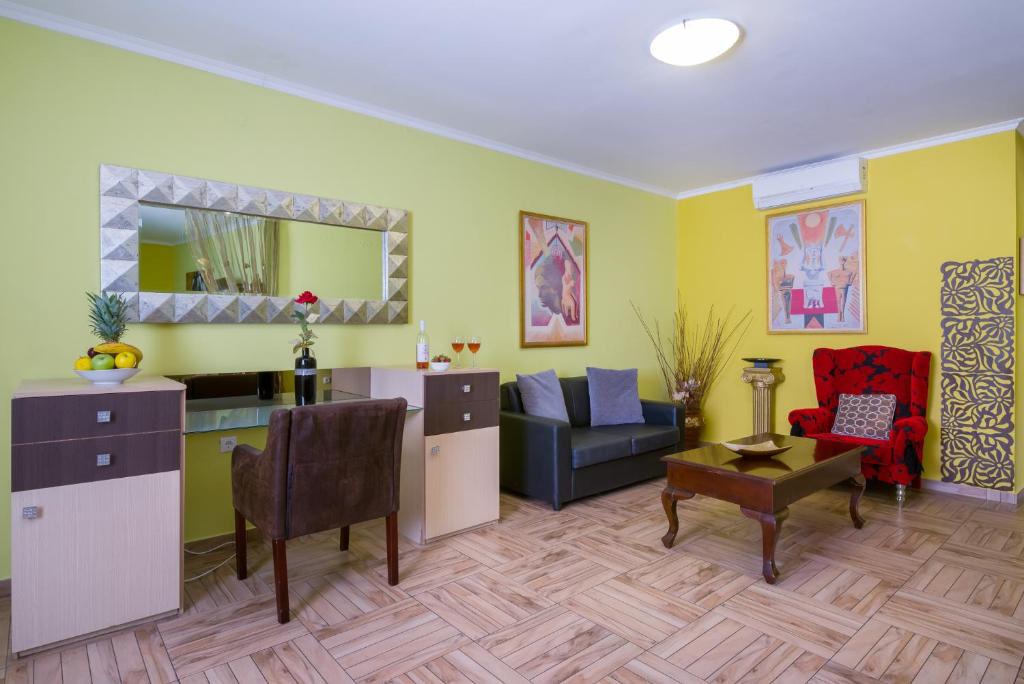 a living room with a couch and a table at Paradice Hotel Luxury Suites-Near zorbas Beach-FREE Breakfast in Stavros