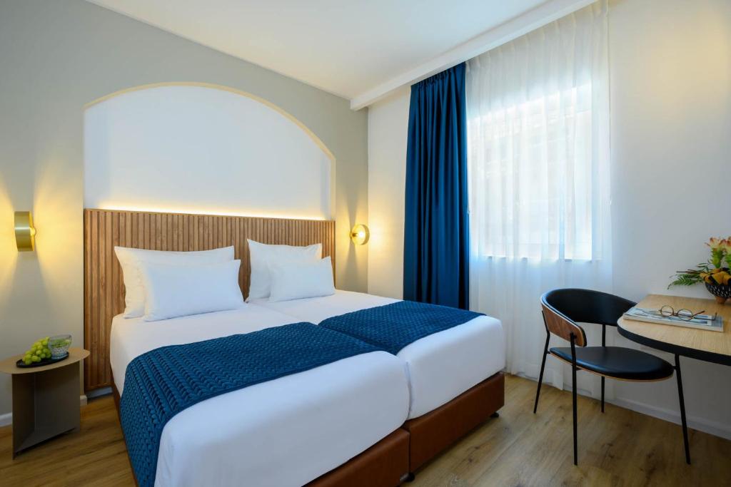 Postel nebo postele na pokoji v ubytování Prima Palace Hotel