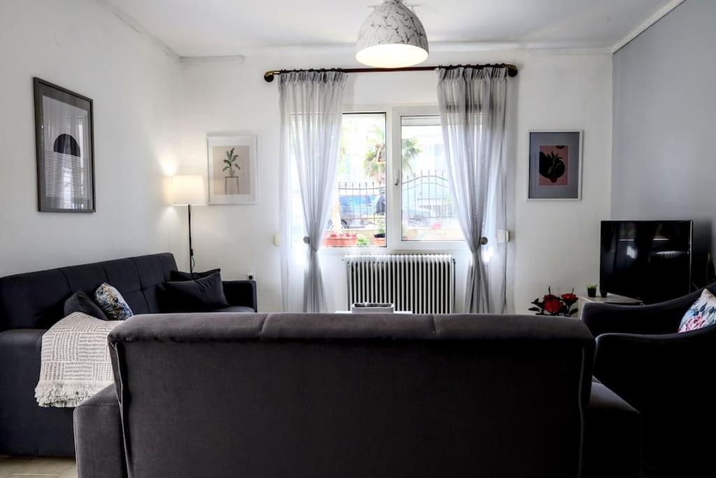 un soggiorno con divano e finestra di Διαμέρισμα κοντά στην παραλιακή a Alexandroupoli
