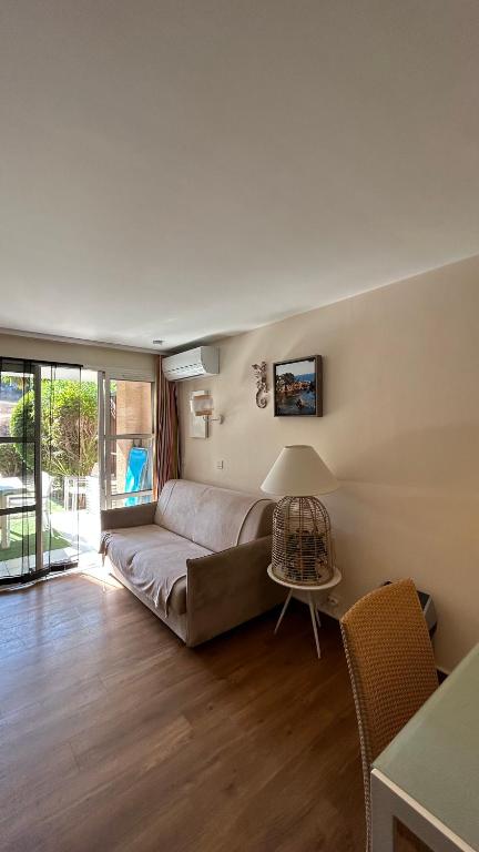 a living room with a couch and a table at L'écrin du Cap Esterel in Saint-Raphaël