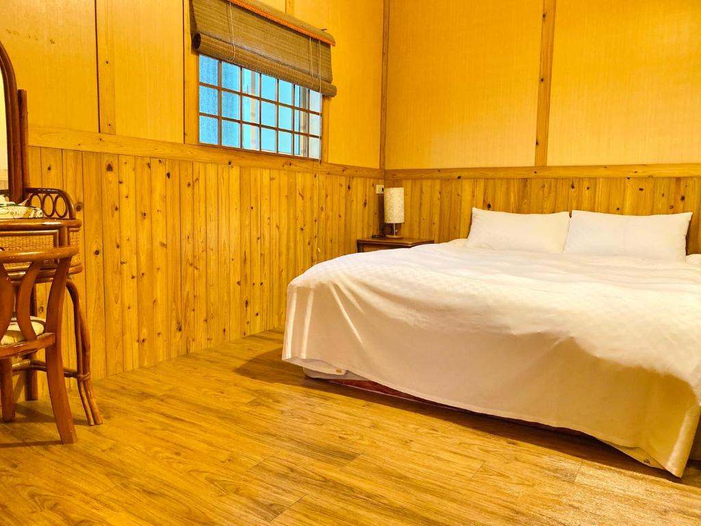Postel nebo postele na pokoji v ubytování 噶瑪蘭ㄟ古厝