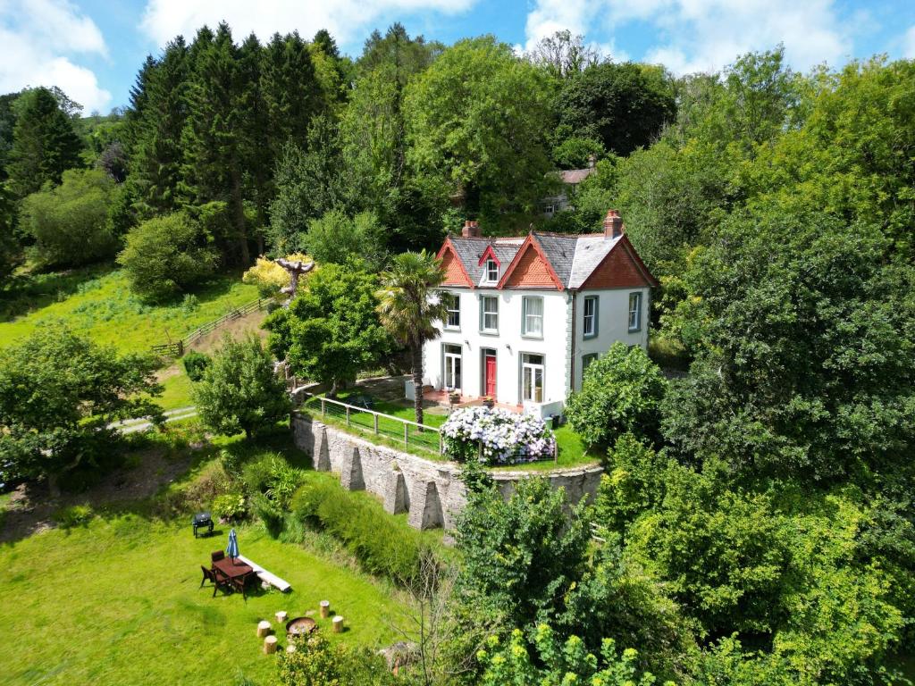 an aerial view of a house on a hill at Serenity Estate in Berrynarbor