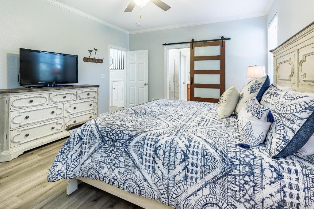 a bedroom with a bed and a tv on a dresser at Destin'd To Be Here in Destin