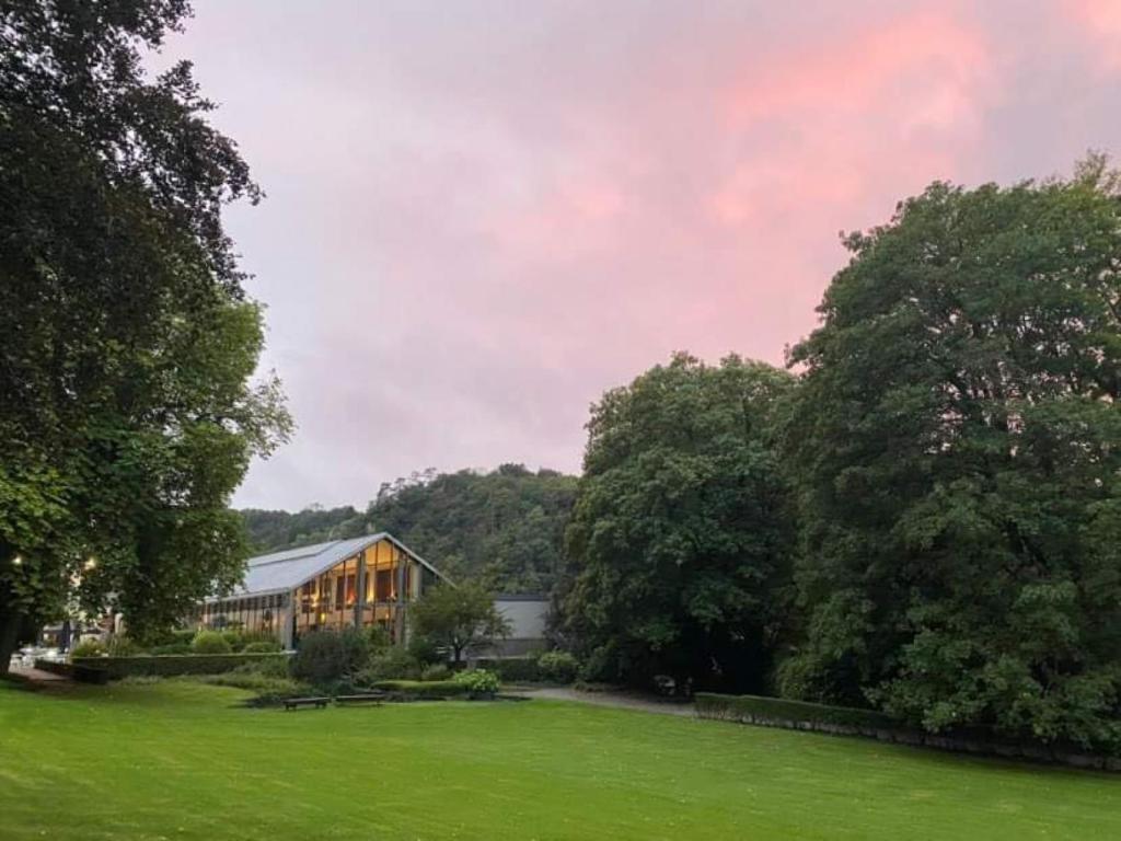 a house in the middle of a green field at Castel de Pont-a-Lesse in Dinant