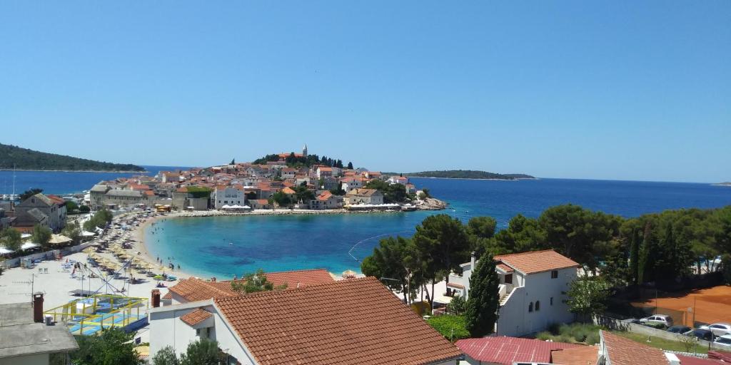 a view of a town with a beach and the ocean at Apartments Toni in Primošten