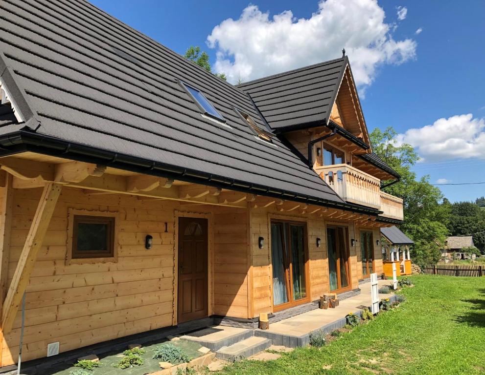 a house with a metal roof on top of it at Osada Witów - Domek we wsi in Witów