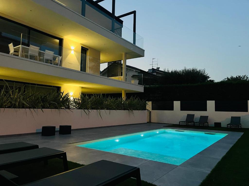 a swimming pool in front of a house at AD Suite Apartment in Riva del Garda
