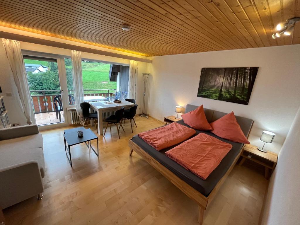 a living room with a bed and a dining room at Haus am Sonnenberg, Todtnauberg, Ferienwohnung 204, direkt am Skilift-Skipiste, Nähe Feldberg in Todtnau