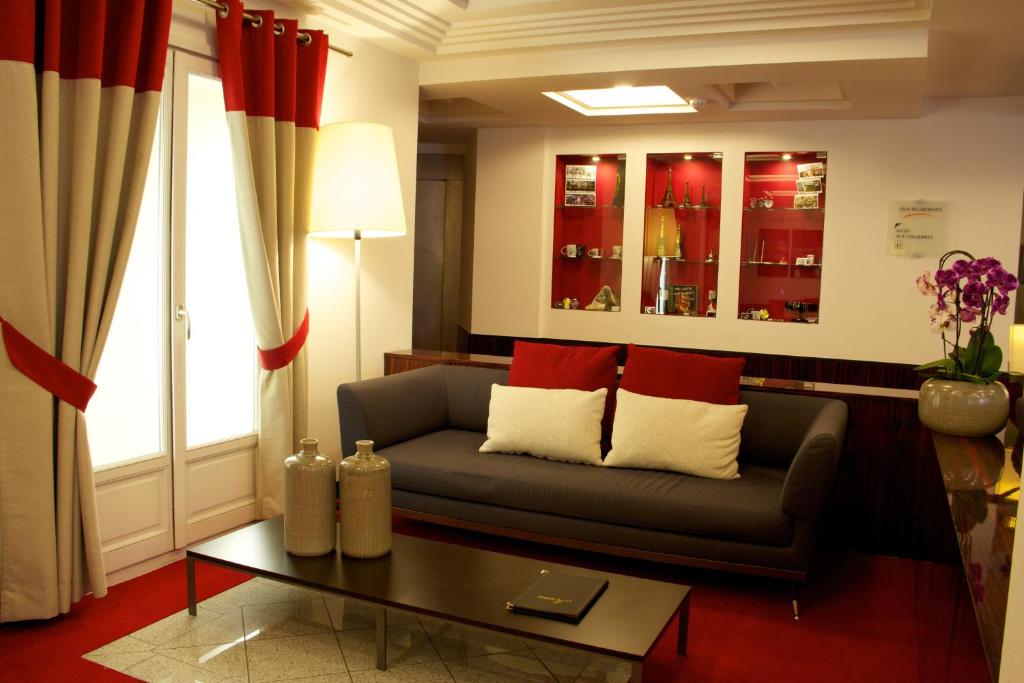 a living room with a couch and a table at Hotel Le Richemont in Paris