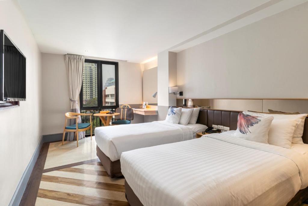 Postel nebo postele na pokoji v ubytování Vince Hotel Pratunam