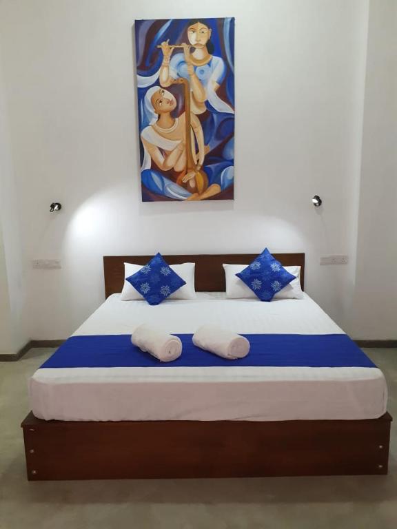 Postel nebo postele na pokoji v ubytování Everdew Kandy Rooms