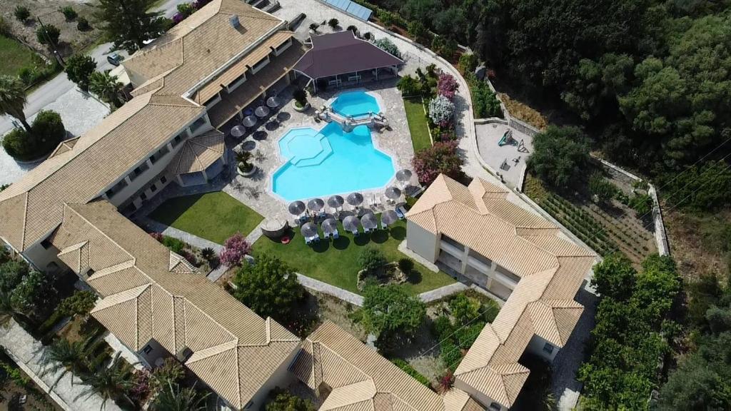 an aerial view of a mansion with a swimming pool at Karavostasi Beach Hotel in Perdika