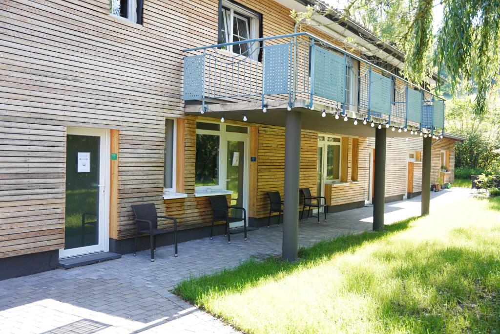 a deck with chairs and a balcony on a house at B&B Alferweiher in Echternach