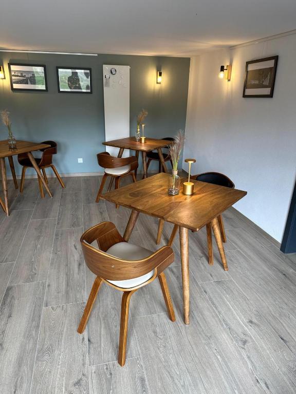 a dining room with wooden tables and chairs at B&B Alferweiher in Echternach