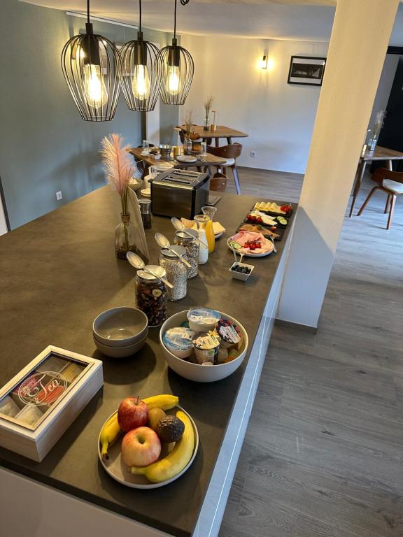 a buffet with many plates of food on a counter at B&B Alferweiher in Echternach