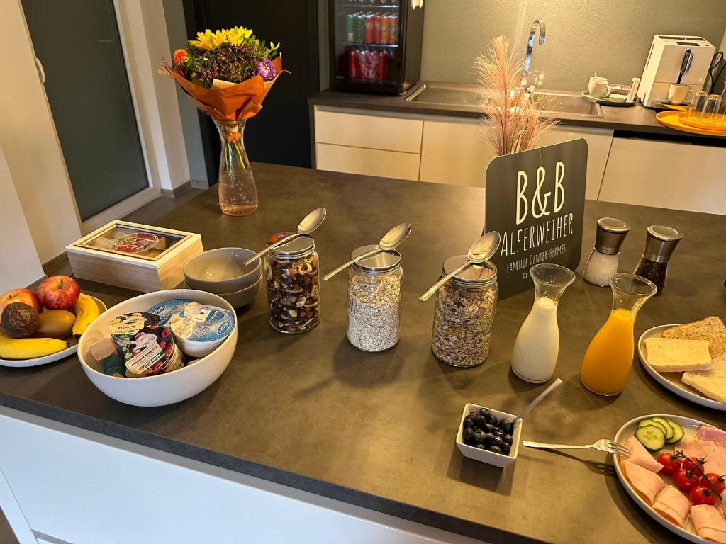 a kitchen counter with a bunch of food on it at B&B Alferweiher in Echternach