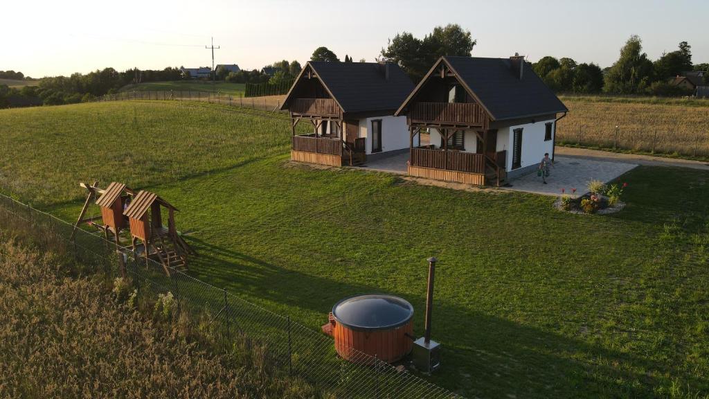 an aerial view of a house in a field at Agroturystyka '' U Adasia i Marysi '' - Domek nad jeziorem in Dębogóry