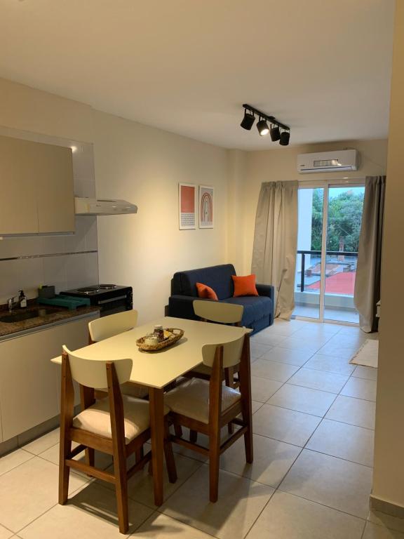 a living room with a table and a blue couch at Amaru - Departamento céntrico con cochera in Corrientes