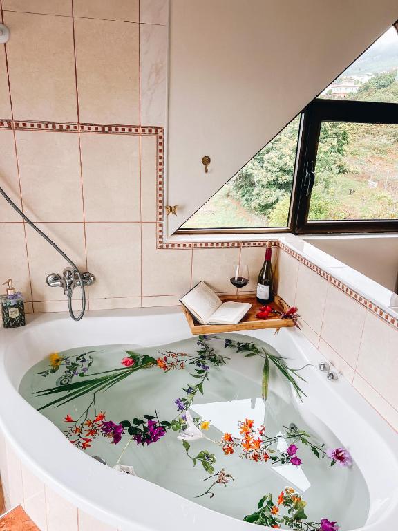 a bath tub with flowers on it in a bathroom at Sun-soaked apt w patio, balcony & garden - Aguilas in La Orotava