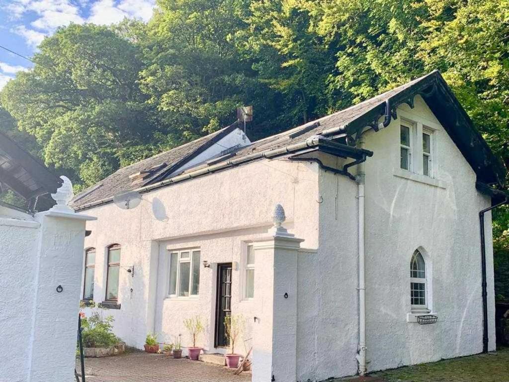 a small white house with a roof at Stunning Cottage in Kilmun Argyll - sleeps 2 in Dunoon