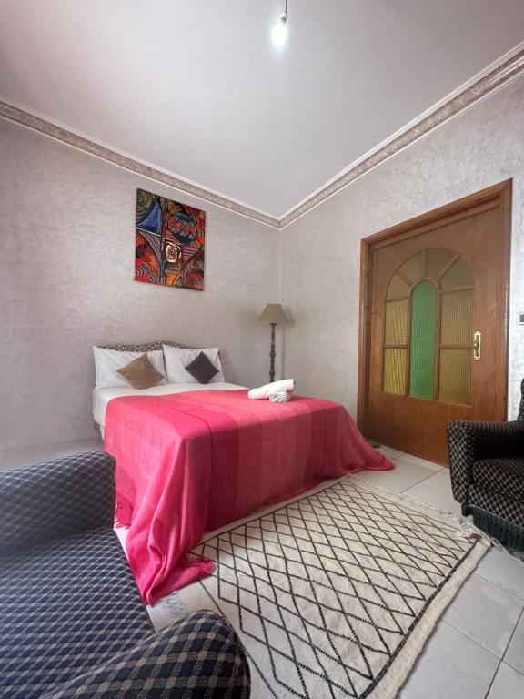 a bedroom with a bed with a pink blanket at House with sea view in Kasbah in Tangier
