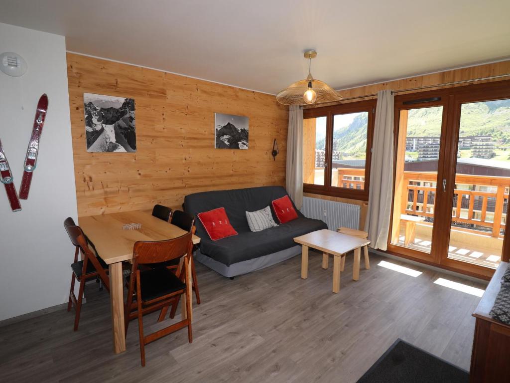 a living room with a couch and a table at Appartement Confort 4 Pers, Balcon Sud, Proche Pistes et Commerces, WIFI Inclus - FR-1-502-406 in Tignes