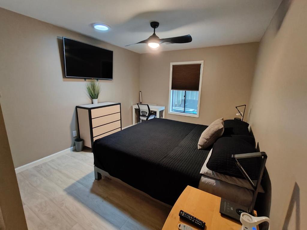 a bedroom with a bed and a flat screen tv at Modern/Retro Condo in High Point