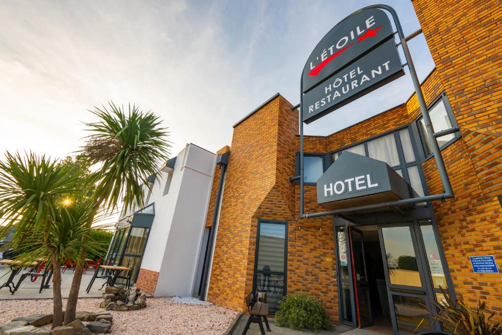 a hotel with a sign in front of it at Hôtel L'Etoile Aéroport - A61 in Carcassonne
