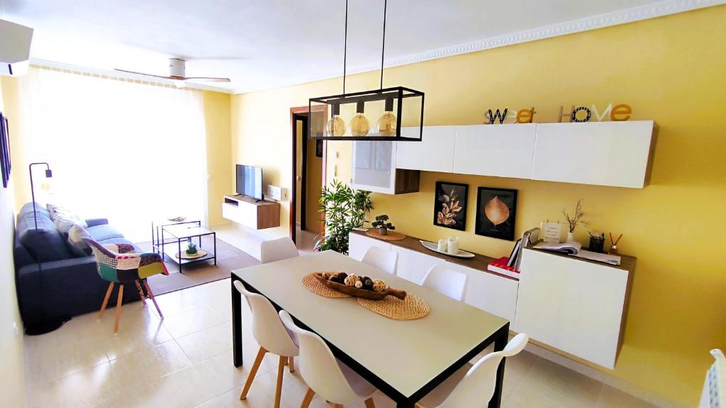 a kitchen with a table and chairs in a room at Good Atmosphere Apartment in El Vendrell