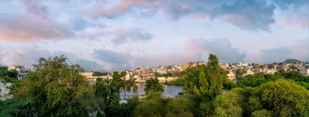 Soham Haveli Udaipur في أودايبور: اطلالة على مدينة بها نهر ومباني