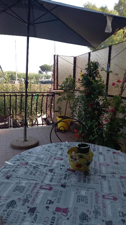 a table with a table cloth on top of a patio at A Santy's House 1piano no lift no shuttle solo parcheggio in strada 5 minuti da fermata bus per da fiera di roma nessun pasto no meal, air condiz ed extra bed FOR A FEE A PAGAMENTO in Fiumicino