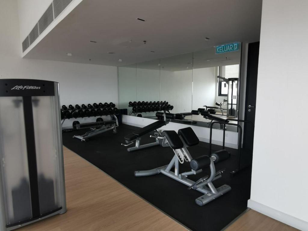 a gym with several treadmills and exercise machines at Harmonee Homes - Mode Chill at The Hub SS2, PJ in Petaling Jaya