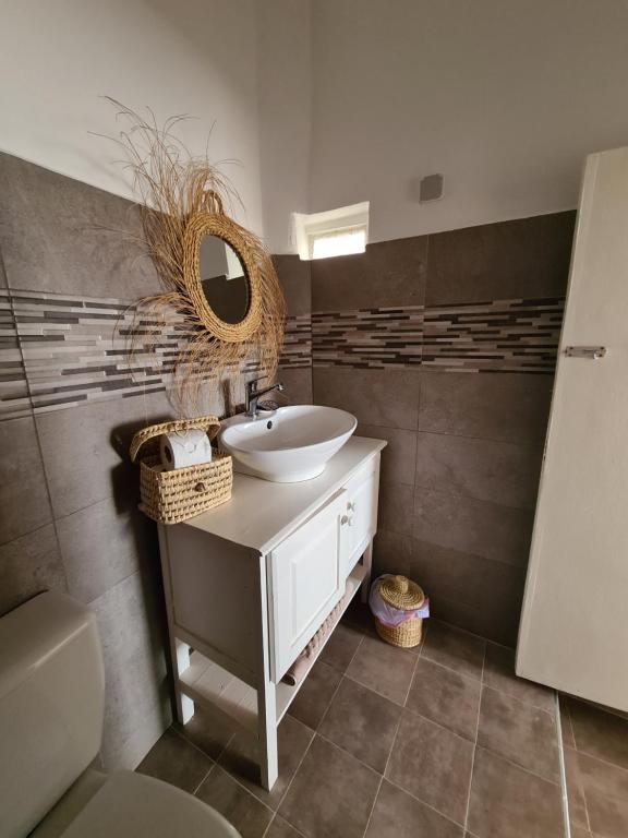 a bathroom with a sink and a mirror at La Maison des Vagues in Sidi Kaouki