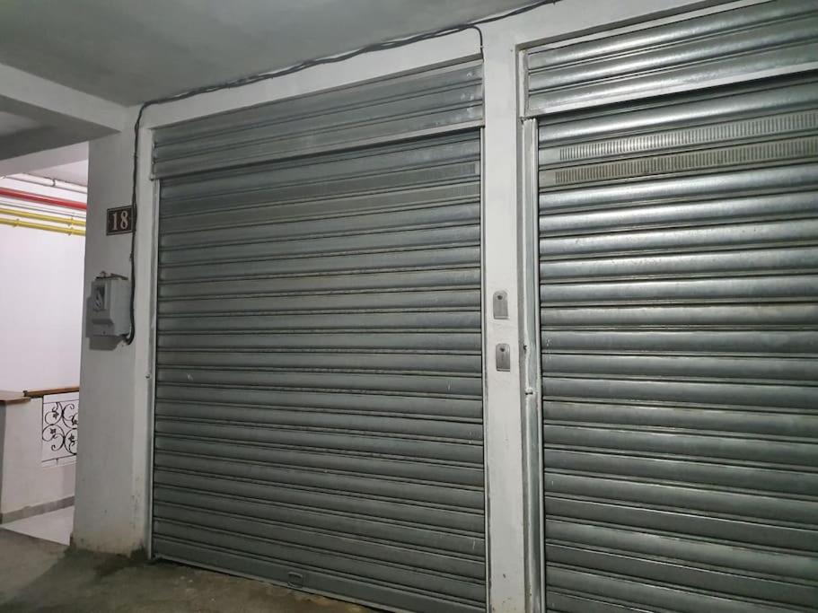 a pair of metal garage doors in a building at YEMMA GOURAYA LOFT in Bejaïa