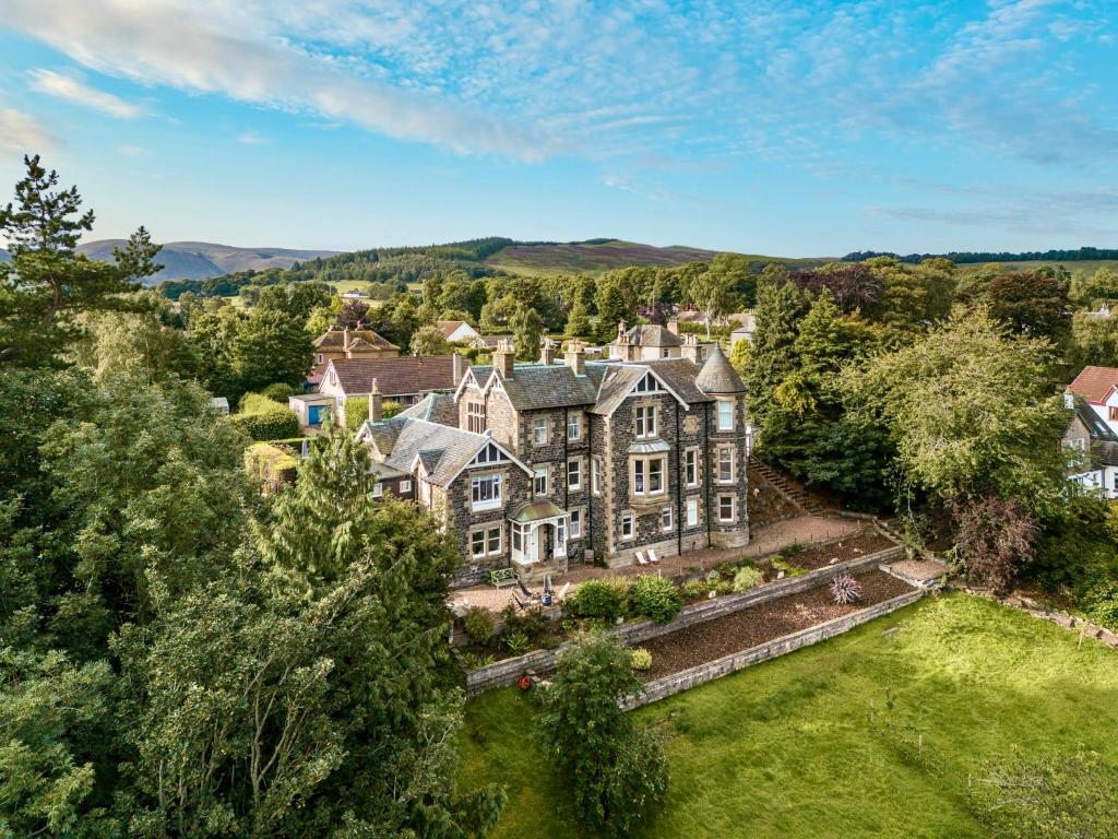 an aerial view of a mansion with a yard at Dilkusha, Peebles in Peebles