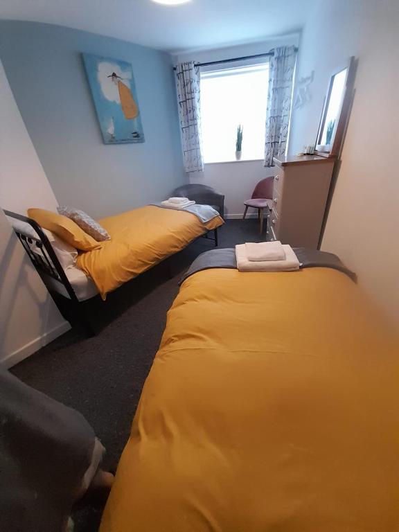 a bedroom with two beds and a window at Flat 5 Corner House 1 bedroom in Doncaster