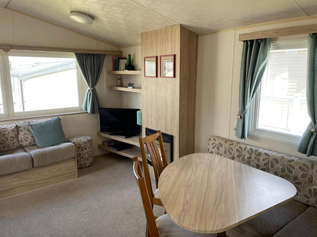 una pequeña sala de estar con mesa y sofá en The Breakaway, en Rochester