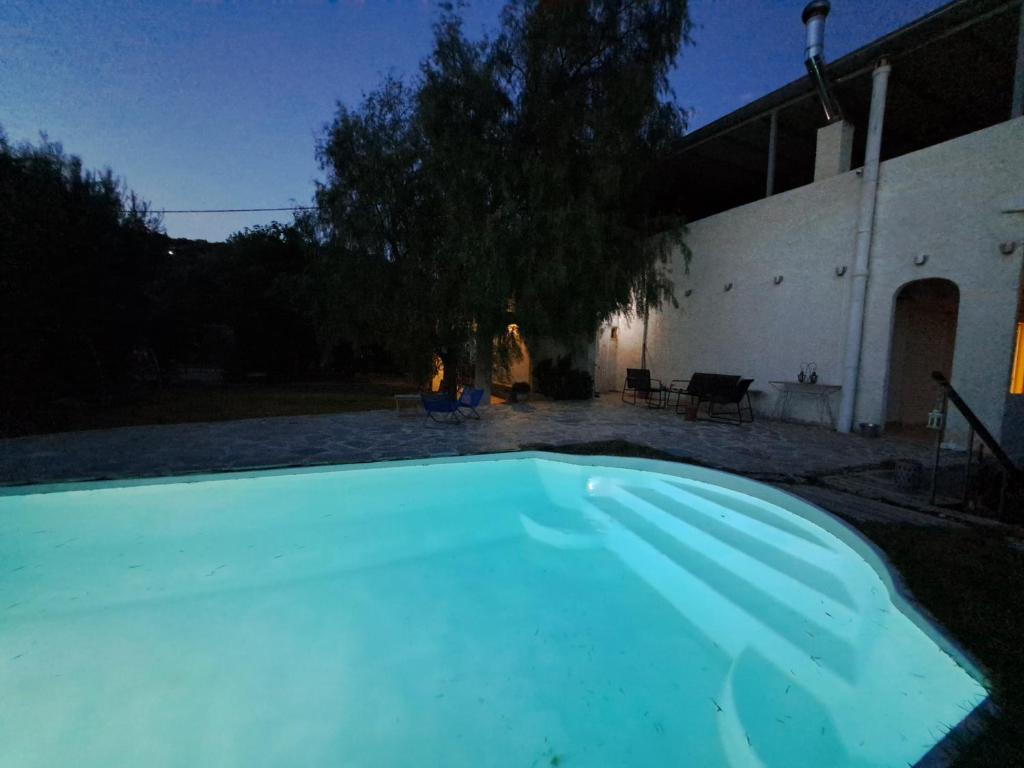 a large swimming pool in a yard at night at dreamcatcher in Anavyssos