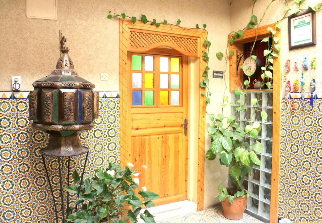 a door of a house with a plant next to it at Riad Les Chtis D'Agadir in Agadir